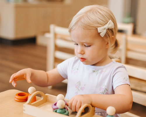 toddler at sonnet montessori playing with blocks